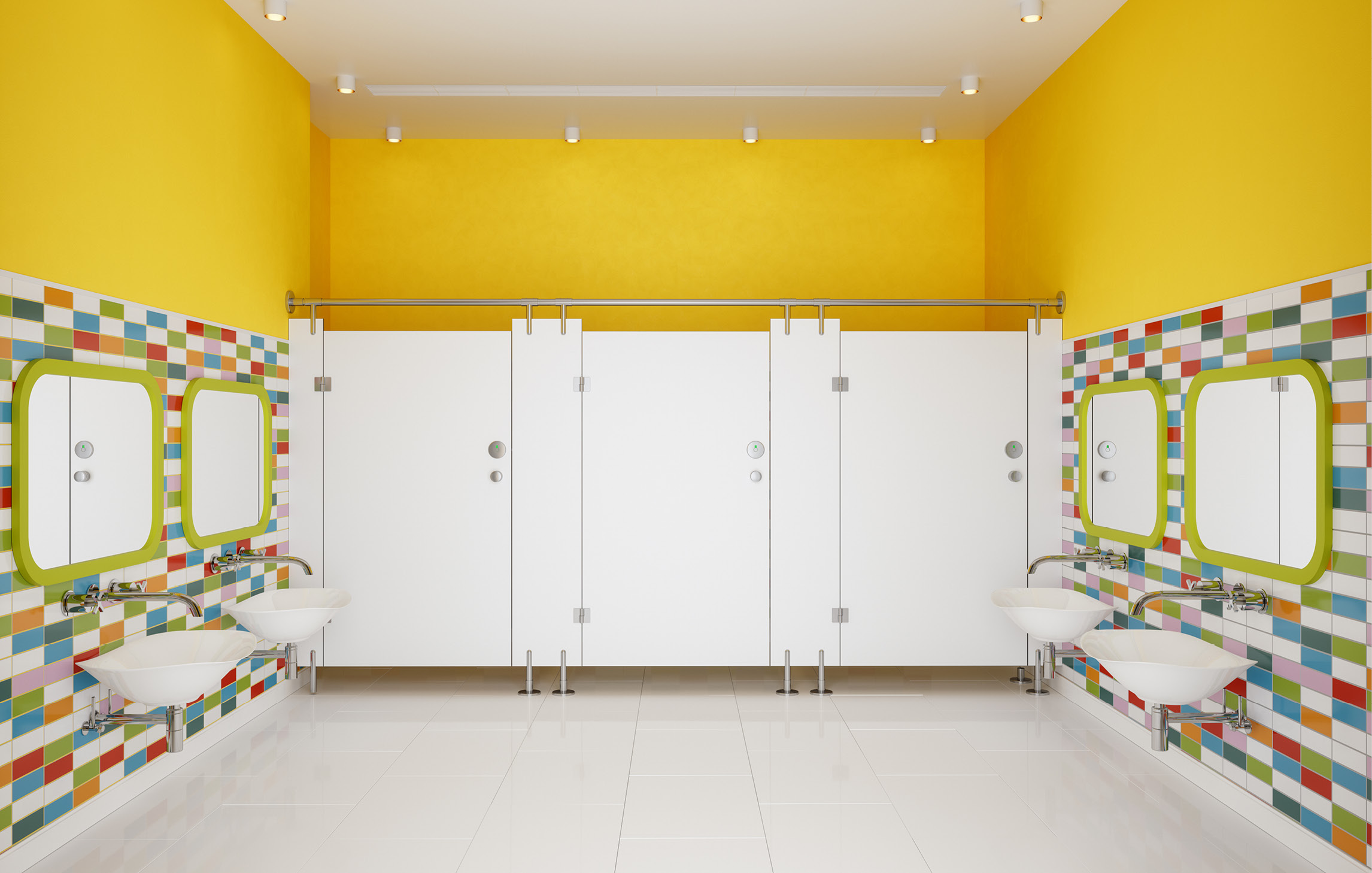 Foto eines Waschraums für Kinder mit bunten Kacheln und gelben Wänden
